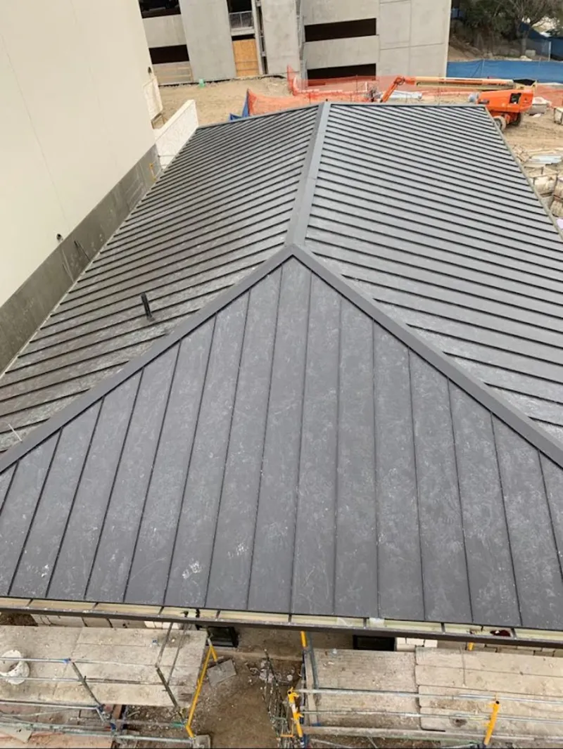 Commercial metal roof construction with crane equipment in Urban Honolulu