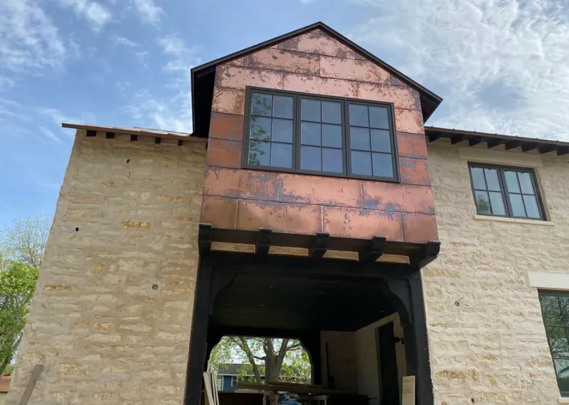 Copper metal panel facade on a stone building for Skylight Installation in Urban Honolulu