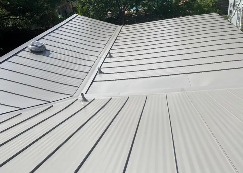Solar attic fan installed on a metal roof for Roof Ventilation in Urban Honolulu